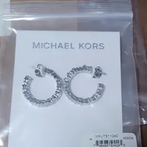 Michael Kors Women's Silver-Tone Brass Hoop Earring (Model: MKJ7311040)
