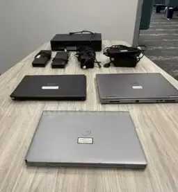 3 Used Dell Laptops, 4 Used Dell Docking Stations, and 1 DVD/VCR Player